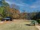 Landscaped backyard with stone gazebo and pond view at 595 S Mount Carmel Rd, Mcdonough, GA 30253