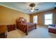 Comfortable bedroom with hardwood floors and a sitting area at 595 S Mount Carmel Rd, Mcdonough, GA 30253