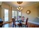 Charming breakfast room features a glass-top table and hardwood floors at 595 S Mount Carmel Rd, Mcdonough, GA 30253