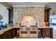 Magnificent kitchen with a stone range hood and high-end professional appliances at 595 S Mount Carmel Rd, Mcdonough, GA 30253