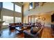 Sunlit living room with hardwood floors, leather furniture, and large windows at 595 S Mount Carmel Rd, Mcdonough, GA 30253