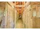 Long hallway in a barn with wooden stalls and wire mesh at 11790 Brown Bridge Rd, Covington, GA 30016