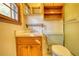 Bathroom with light green toilet, wooden vanity, and shower at 11790 Brown Bridge Rd, Covington, GA 30016