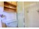 Bathroom with light green toilet, shower, and wooden storage cabinet at 11790 Brown Bridge Rd, Covington, GA 30016