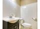 Simple bathroom with white sink, dark vanity, and toilet at 11790 Brown Bridge Rd, Covington, GA 30016