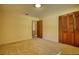 Empty bedroom with carpet, closet, and door to another room at 11790 Brown Bridge Rd, Covington, GA 30016