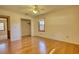 Empty bedroom with hardwood floors, a ceiling fan, and a closet at 11790 Brown Bridge Rd, Covington, GA 30016