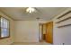Empty bedroom with wall-mounted shelves and carpeted floors at 11790 Brown Bridge Rd, Covington, GA 30016