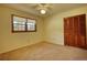 Empty bedroom with two windows, carpet flooring and ceiling fan at 11790 Brown Bridge Rd, Covington, GA 30016