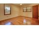 Bedroom with polished hardwood floors and natural light from large windows at 11790 Brown Bridge Rd, Covington, GA 30016