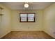 Empty bedroom with two windows, carpet flooring and ceiling fan at 11790 Brown Bridge Rd, Covington, GA 30016