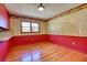 Dining area with hardwood floors, red wainscoting, and decorative wallpaper at 11790 Brown Bridge Rd, Covington, GA 30016