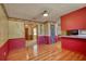 Dining area with hardwood floors and distinctive red and textured wallpaper at 11790 Brown Bridge Rd, Covington, GA 30016