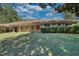 Charming single-Gathering home with a carport, lush green lawn, and mature trees at 11790 Brown Bridge Rd, Covington, GA 30016