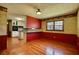 Kitchen and dining area with red walls, hardwood floors, and a breakfast bar at 11790 Brown Bridge Rd, Covington, GA 30016