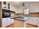 Kitchen with stainless steel appliances, black granite island, and white cabinets at 11790 Brown Bridge Rd, Covington, GA 30016