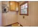 Simple laundry room with wood paneling and built-in cabinets at 11790 Brown Bridge Rd, Covington, GA 30016