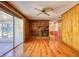 Living room with hardwood floors, brick fireplace, ceiling fan, and access to a sunroom at 11790 Brown Bridge Rd, Covington, GA 30016
