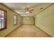 Spacious, empty living room with green walls, windows, and carpet at 11790 Brown Bridge Rd, Covington, GA 30016
