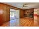 Living room with hardwood floors, brick fireplace, and sliding glass doors to a sunroom at 11790 Brown Bridge Rd, Covington, GA 30016