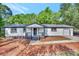 White house with gray accents, a covered front porch, and well-manicured landscaping at 2139 Rosebud Rd, Grayson, GA 30017