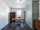 Home office featuring a rustic wooden desk, dark hardwood floors, and a teal brick accent wall at 2750 Cedarbrook Dr, Marietta, GA 30066