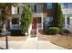 Front entrance of a brick townhouse featuring a red door and white railings at 3262 Cascade Parc Sw Blvd, Atlanta, GA 30311