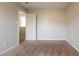 Neutral-toned bedroom with carpet and door to another room at 120 Arlie Rd, Stockbridge, GA 30281