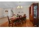 Elegant dining room featuring hardwood floors, chandelier, and wooden furniture at 3851 Village Main St, Loganville, GA 30052