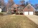 Brick two-story house with a two-car garage and landscaped yard at 2108 Boulder Chase Ct, Ellenwood, GA 30294