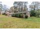 Brick ranch house with a large grassy yard and trees at 2348 Clifton Springs Mnr, Decatur, GA 30034