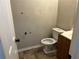 Bathroom with toilet, vanity, and patterned wallpaper at 125 Belmont Farms Dr, Ellenwood, GA 30294