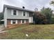 Two-story house with brick and siding, satellite dish, and mature landscaping at 125 Belmont Farms Dr, Ellenwood, GA 30294