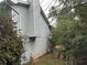 Side exterior of the house with some vegetation and greenery around at 125 Belmont Farms Dr, Ellenwood, GA 30294