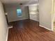 Living area with wood-look floors, fireplace, and a view of the staircase at 125 Belmont Farms Dr, Ellenwood, GA 30294
