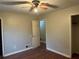 Spacious main bedroom with wood-look floors, ceiling fan, and an open door at 125 Belmont Farms Dr, Ellenwood, GA 30294