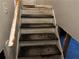 Worn wooden staircase leading to an unfinished area at 125 Belmont Farms Dr, Ellenwood, GA 30294
