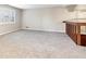 Spacious living room with grey carpet and a wooden railing overlooking the stairs at 5224 Deering Trl, Marietta, GA 30068