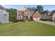 Two-story brick home with a three-car garage and manicured lawn at 1721 Telfair Chase Way, Lawrenceville, GA 30043