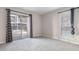 Bright bedroom with grey carpet and sliding glass door at 201 Granville Ct, Atlanta, GA 30328