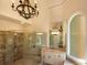 Elegant bathroom with soaking tub, walk-in shower, and chandelier at 8135 Saint Marlo Country Club Pkwy, Duluth, GA 30097