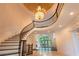 Stunning curved staircase in a two-story entryway at 8135 Saint Marlo Country Club Pkwy, Duluth, GA 30097