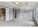 Main bedroom with carpet, door to bathroom, and window at 3014 Heatherton Park Way, Roswell, GA 30075