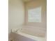 Relaxing bathtub with window in a bright bathroom at 5315 Hopewell Manor Dr, Cumming, GA 30028