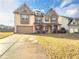 Two-story house with stone accents and a landscaped yard at 5315 Hopewell Manor Dr, Cumming, GA 30028