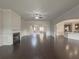 Spacious living room with hardwood floors and fireplace, open to kitchen at 5315 Hopewell Manor Dr, Cumming, GA 30028