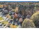 Aerial view showcasing home's curb appeal and wooded lot at 1054 Sunny Field Ln, Lawrenceville, GA 30043