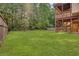 Large backyard with green grass and wooden deck at 1054 Sunny Field Ln, Lawrenceville, GA 30043