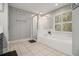 Bathroom featuring a bathtub, shower, and white tile at 1054 Sunny Field Ln, Lawrenceville, GA 30043