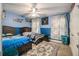 Bedroom with two twin beds, ceiling fan and blue walls at 1054 Sunny Field Ln, Lawrenceville, GA 30043